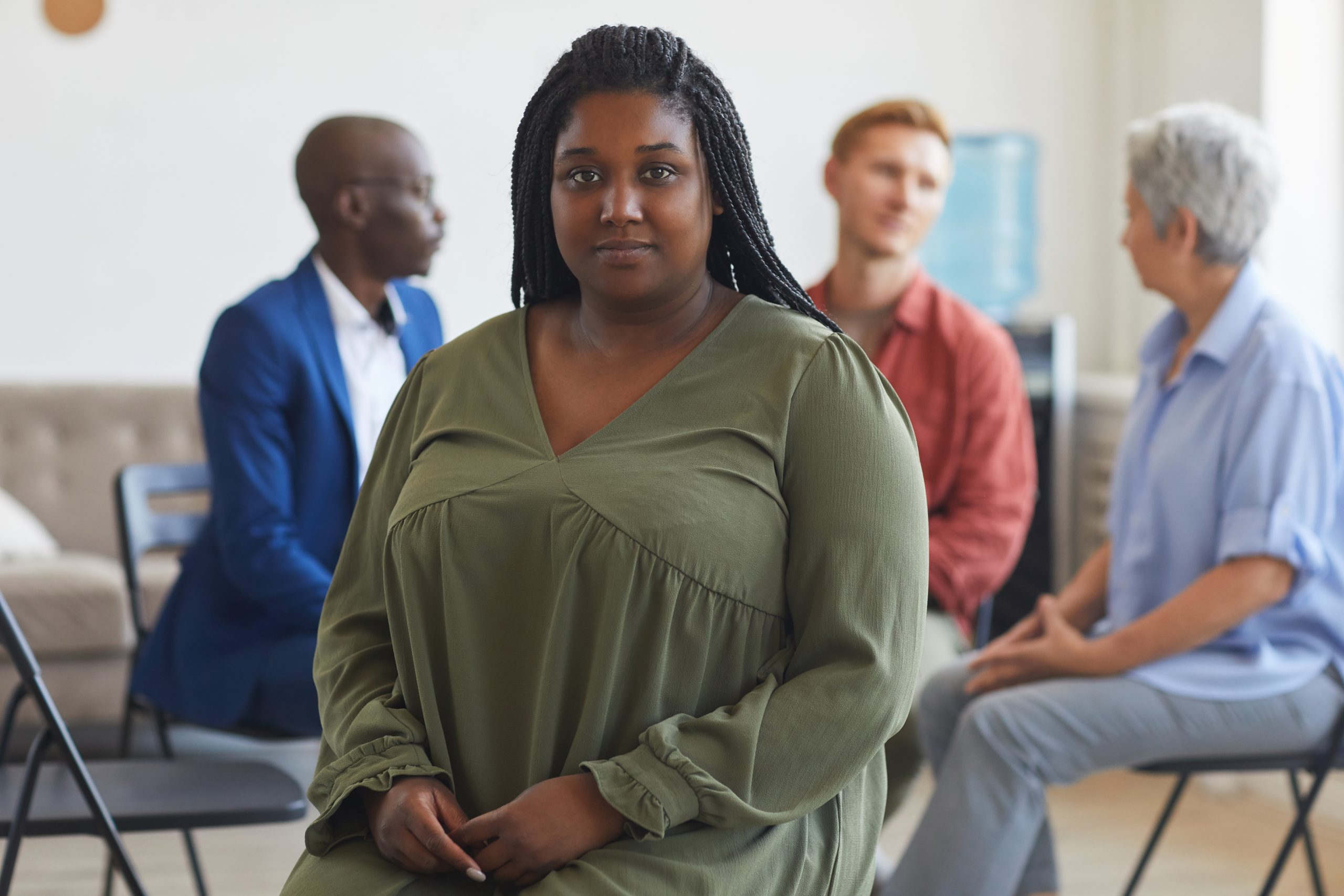 Woman standing next to therapy group