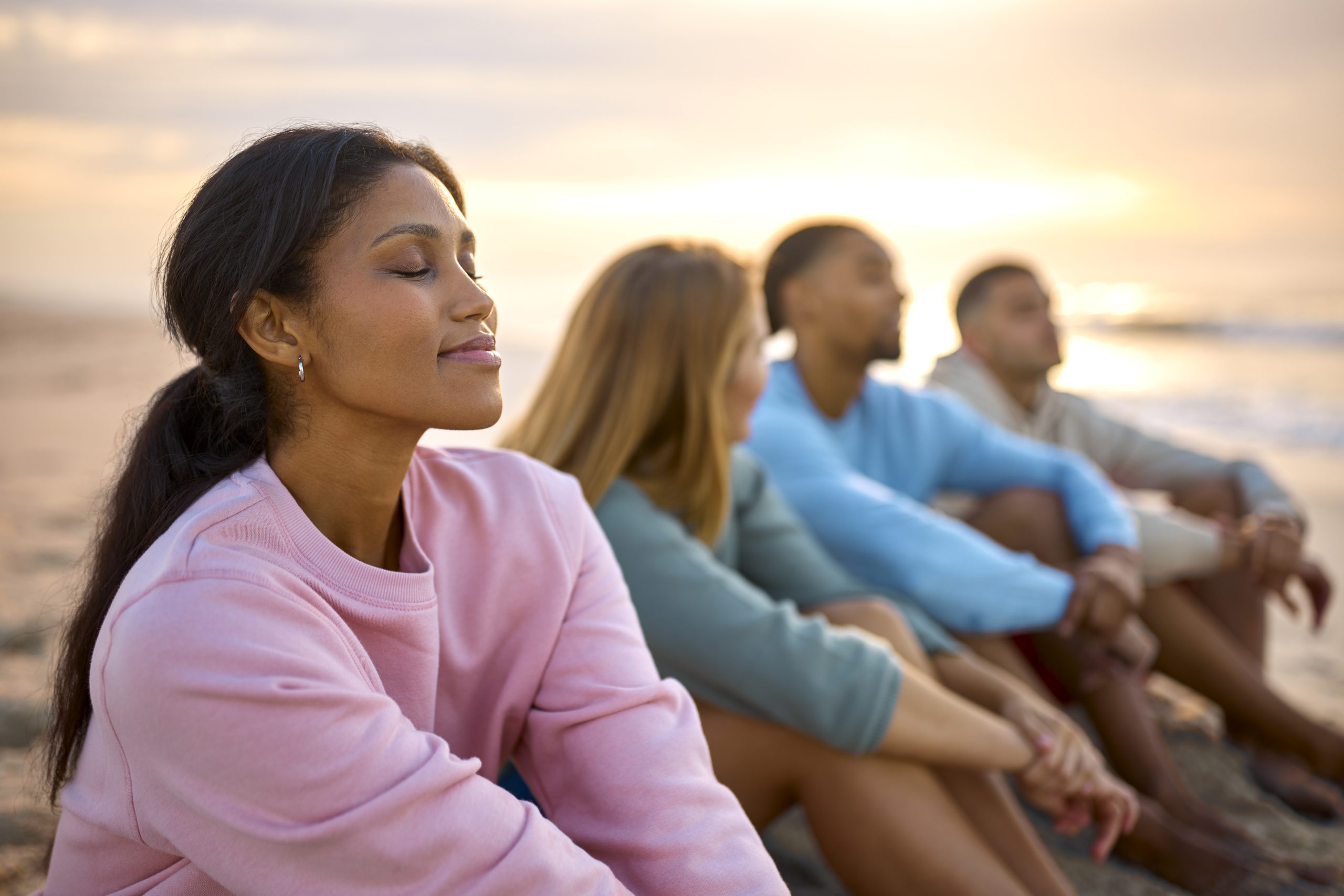 Group sitting together on beach