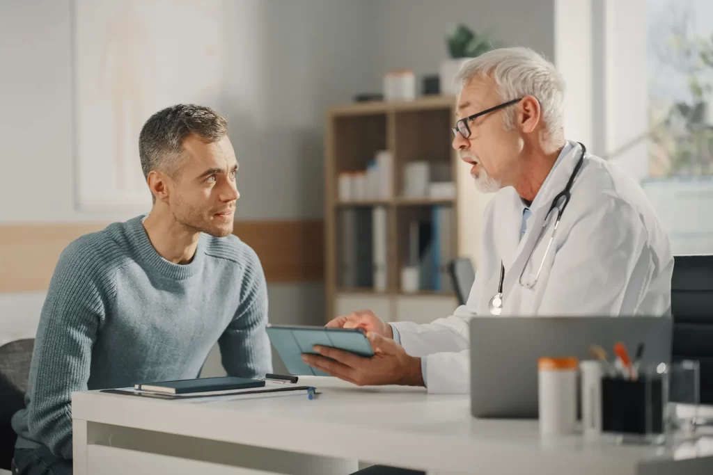 Doctor consulting with a male patient in a medical office