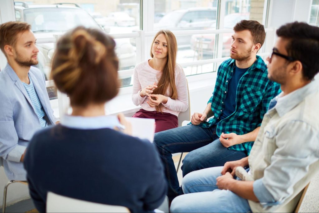 Diverse group of people in group therapy.